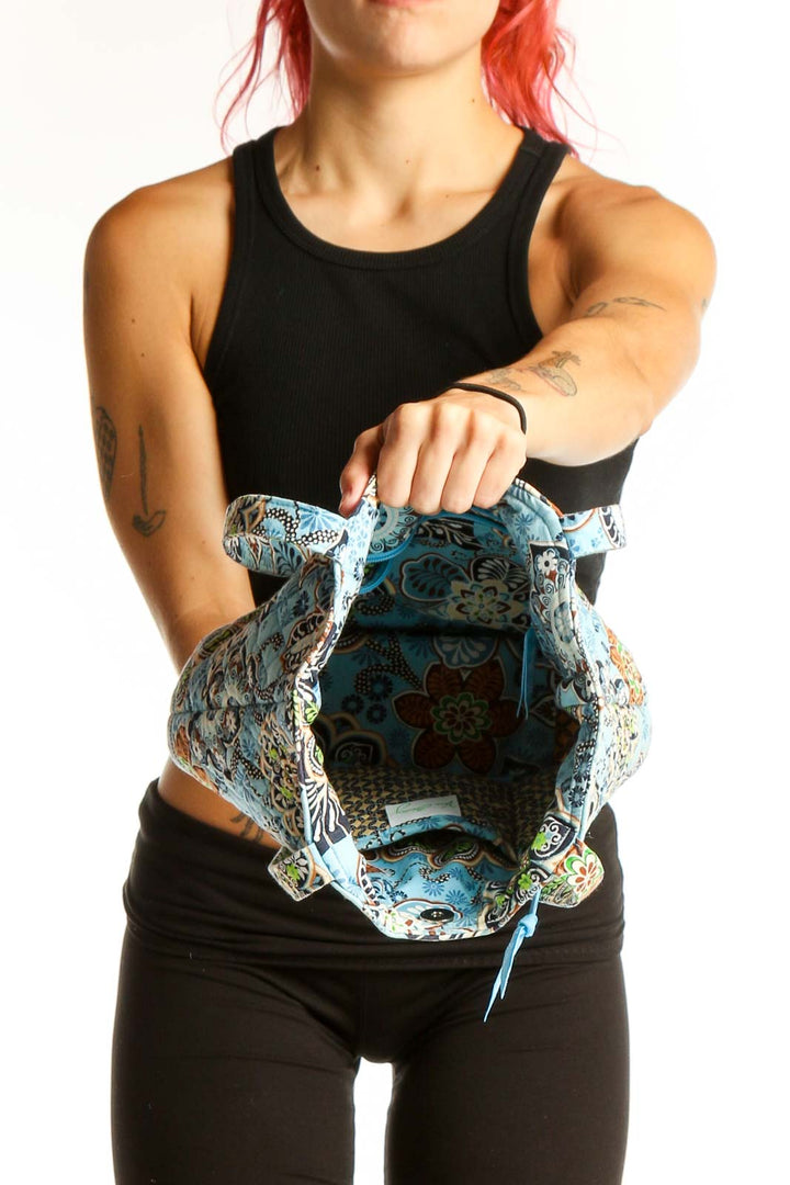 Side view of Vera Bradley Blue Floral Quilted Tote Bag worn on shoulder