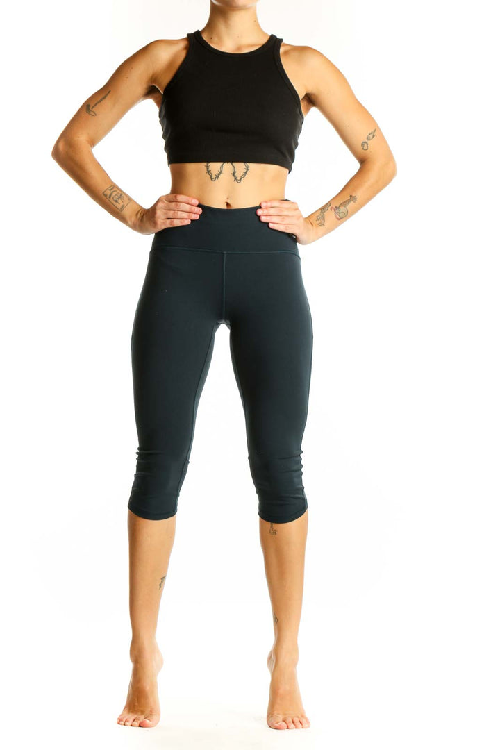 Front view of Lululemon dark green high-waisted capri leggings