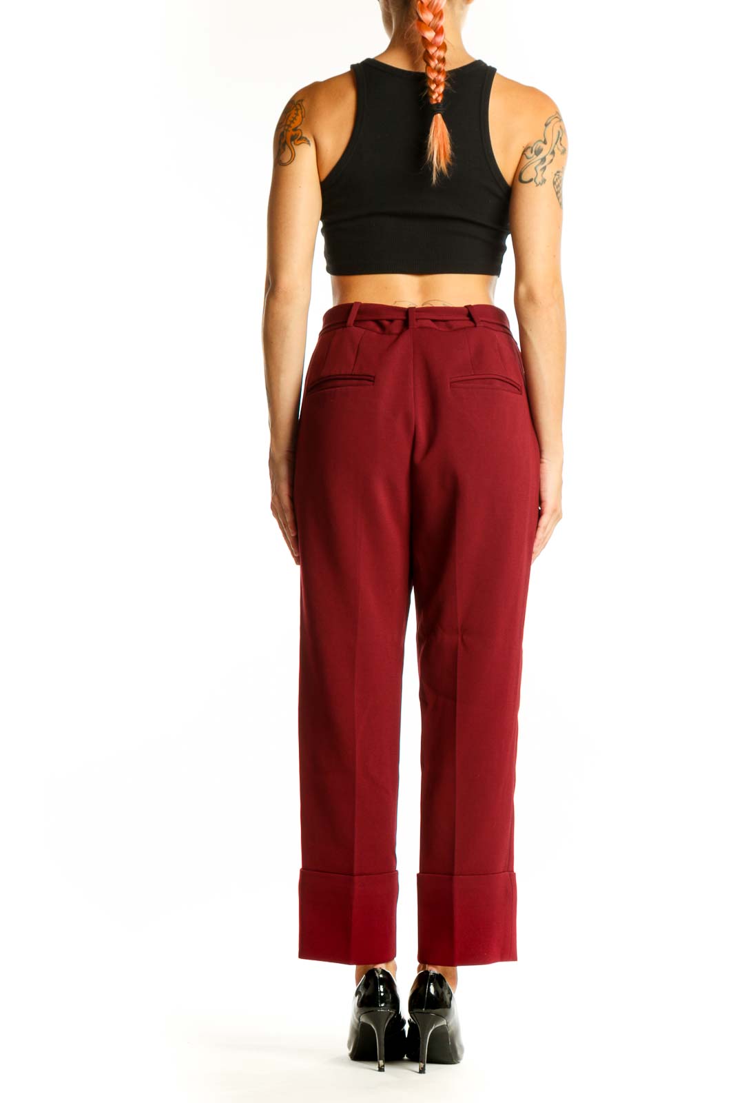 Side view of burgundy wide-leg trousers showing cuffed hems and silhouette