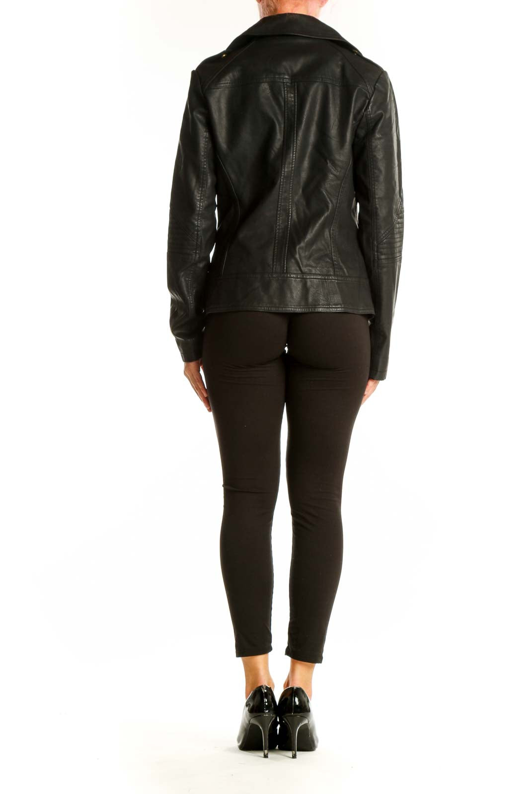 Side view of woman wearing black Guess faux leather moto jacket