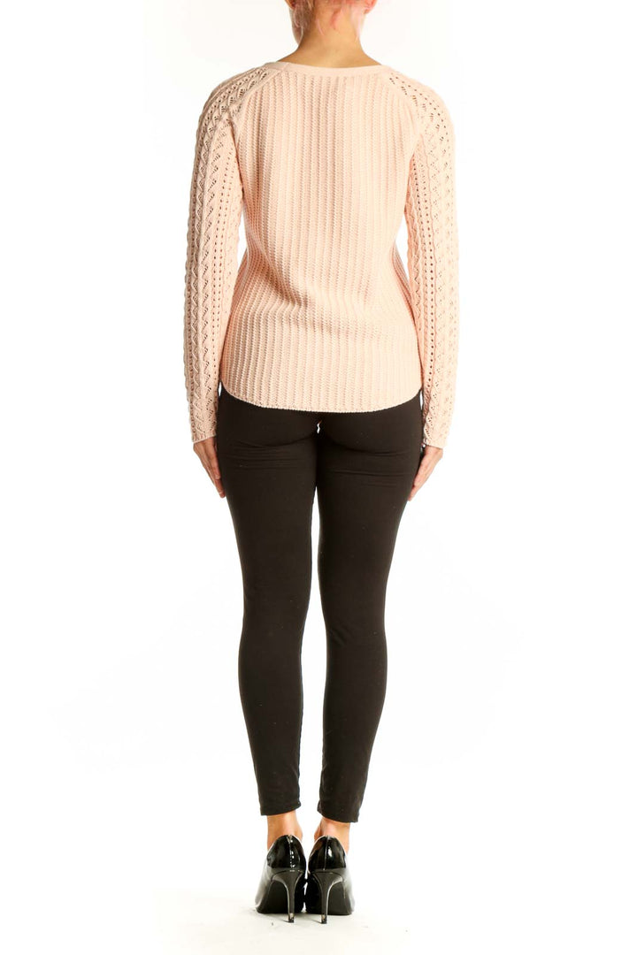 Side view of blush LOFT cotton sweater showing lace sleeve detail