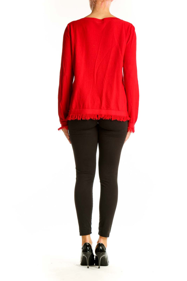 Side view of red Ann Taylor boatneck sweater with fringe trim on woman