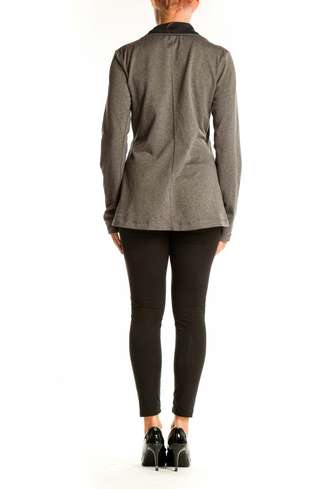 Side view of woman wearing gray Reebok athletic jacket