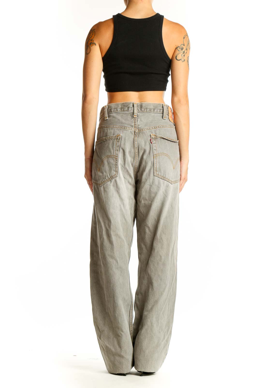 Side view of Levi's light gray wide-leg denim jeans on model with black crop top