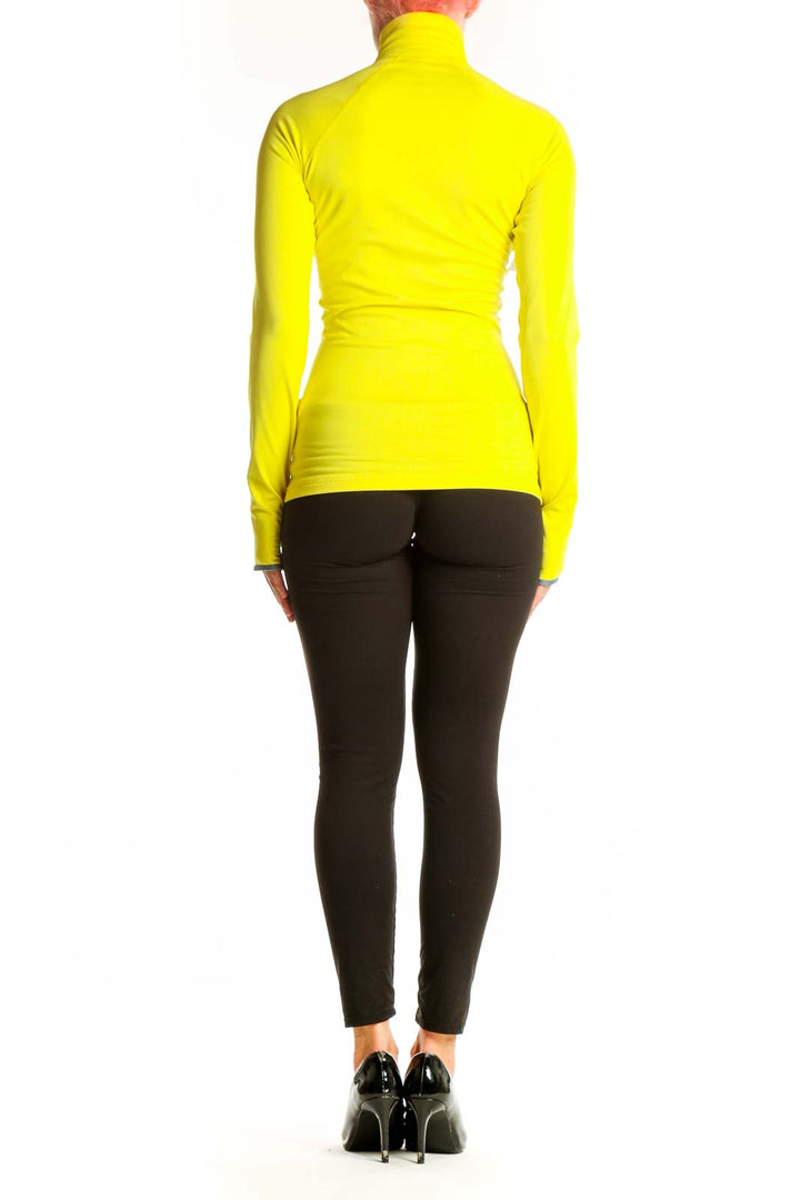 Side view of yellow Nike high-neck half-zip athletic top on model