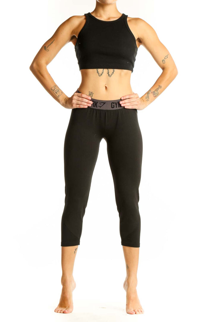 Front view of black Gymshark capri leggings with high waistband