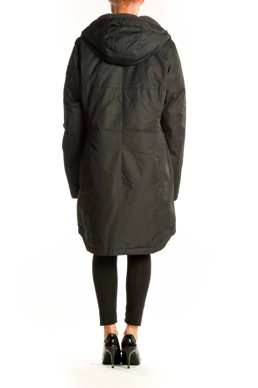 Side view of woman wearing dark green Columbia winter coat