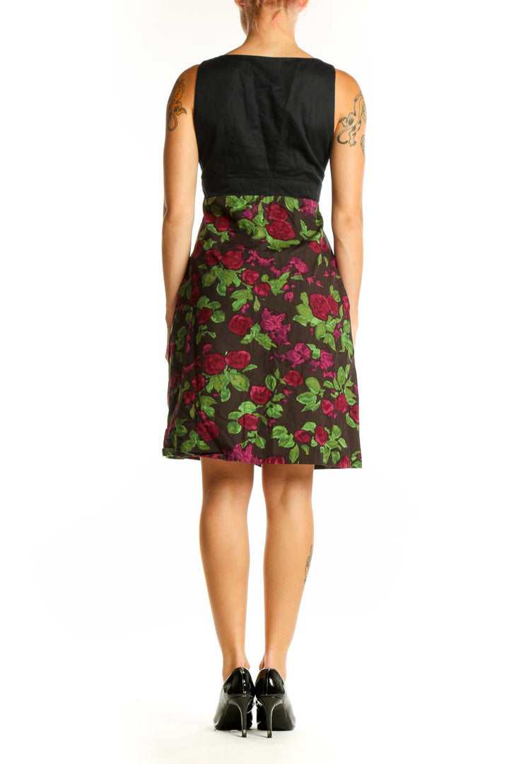 Side view of Moulinette Soeurs black floral dress showing empire waist and A-line silhouette