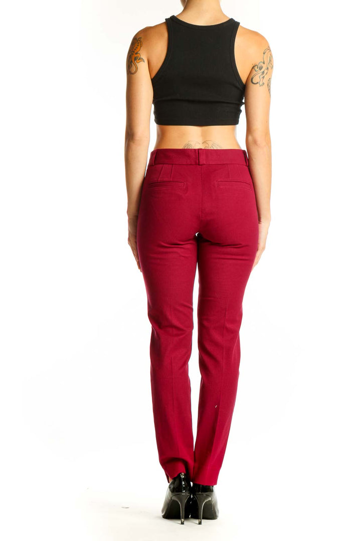 Side view of red slim-fit Banana Republic trousers on model with black crop top