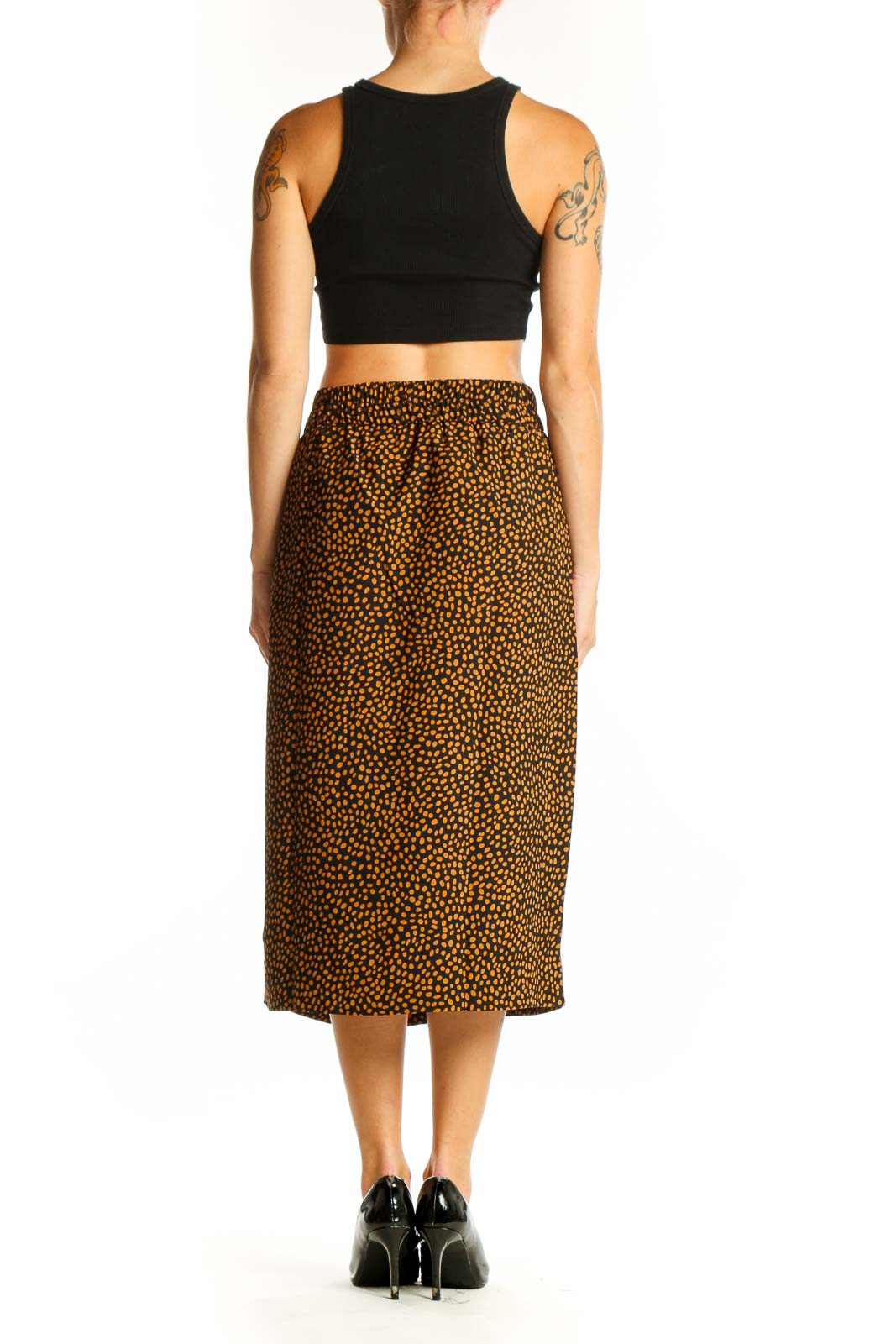 Side view of model wearing J.Crew brown spotted midi skirt with black top