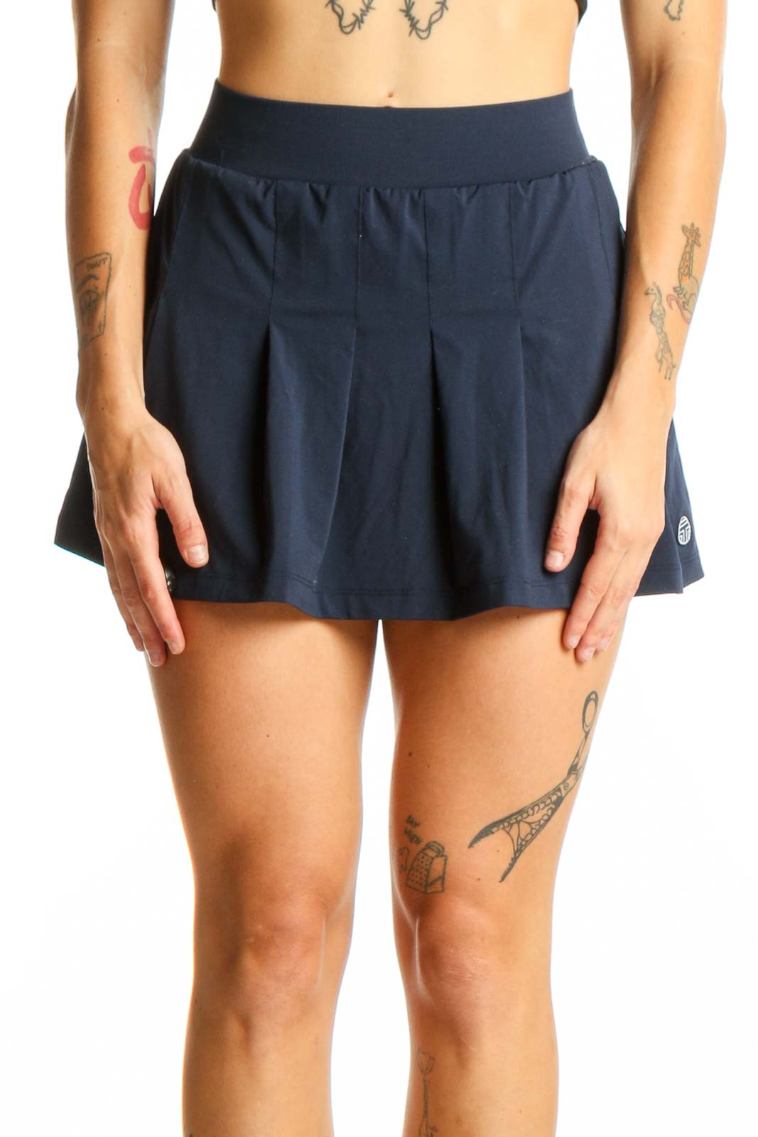 Front view of TORY SPORT navy pleated tennis skirt