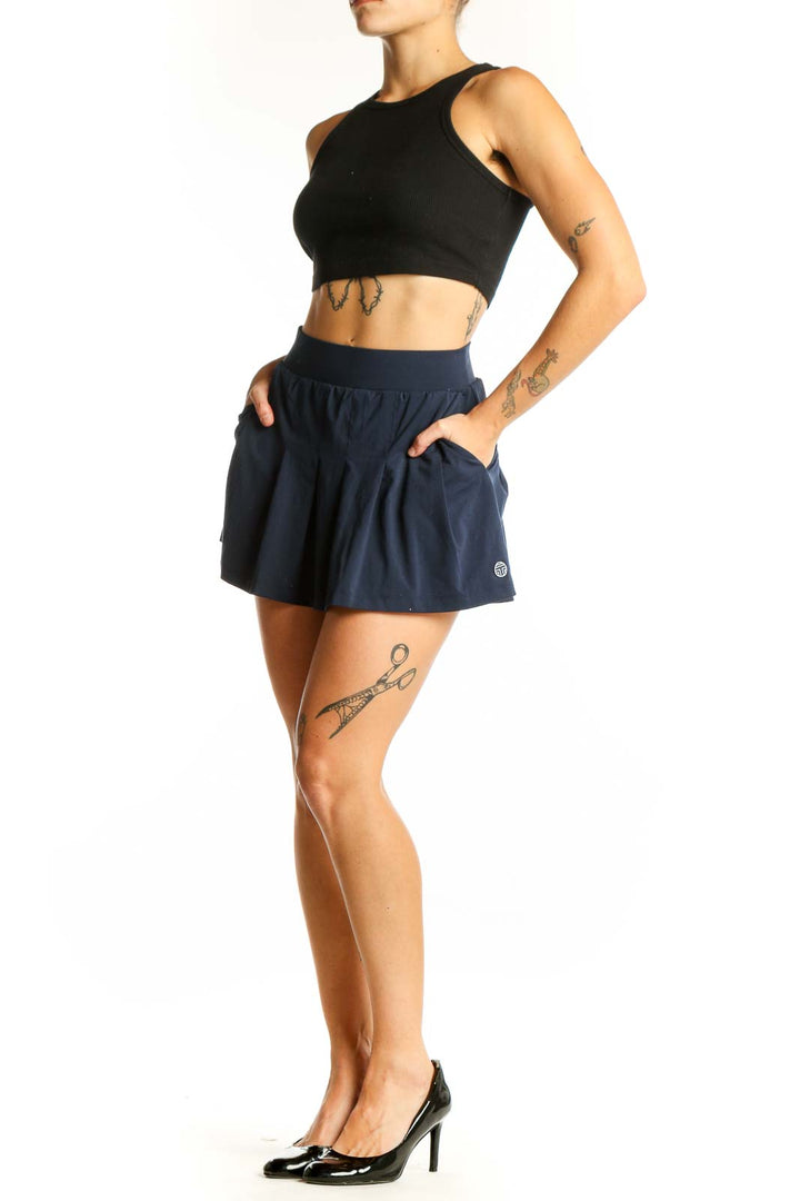 Front view of TORY SPORT navy pleated tennis skirt