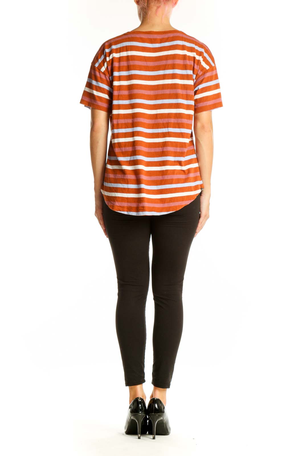 Side view of model wearing Madewell orange striped short-sleeve tee with black pants