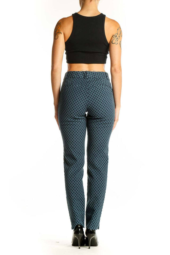 Side view of woman wearing Banana Republic blue geometric print pants with black top