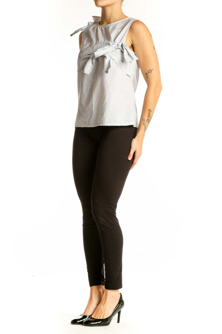 Front view of light gray sleeveless cotton top with bow details