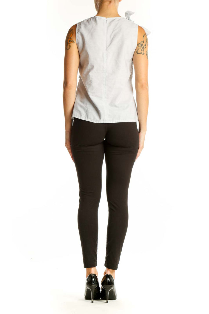 Side view of light gray sleeveless cotton top showing bow accent