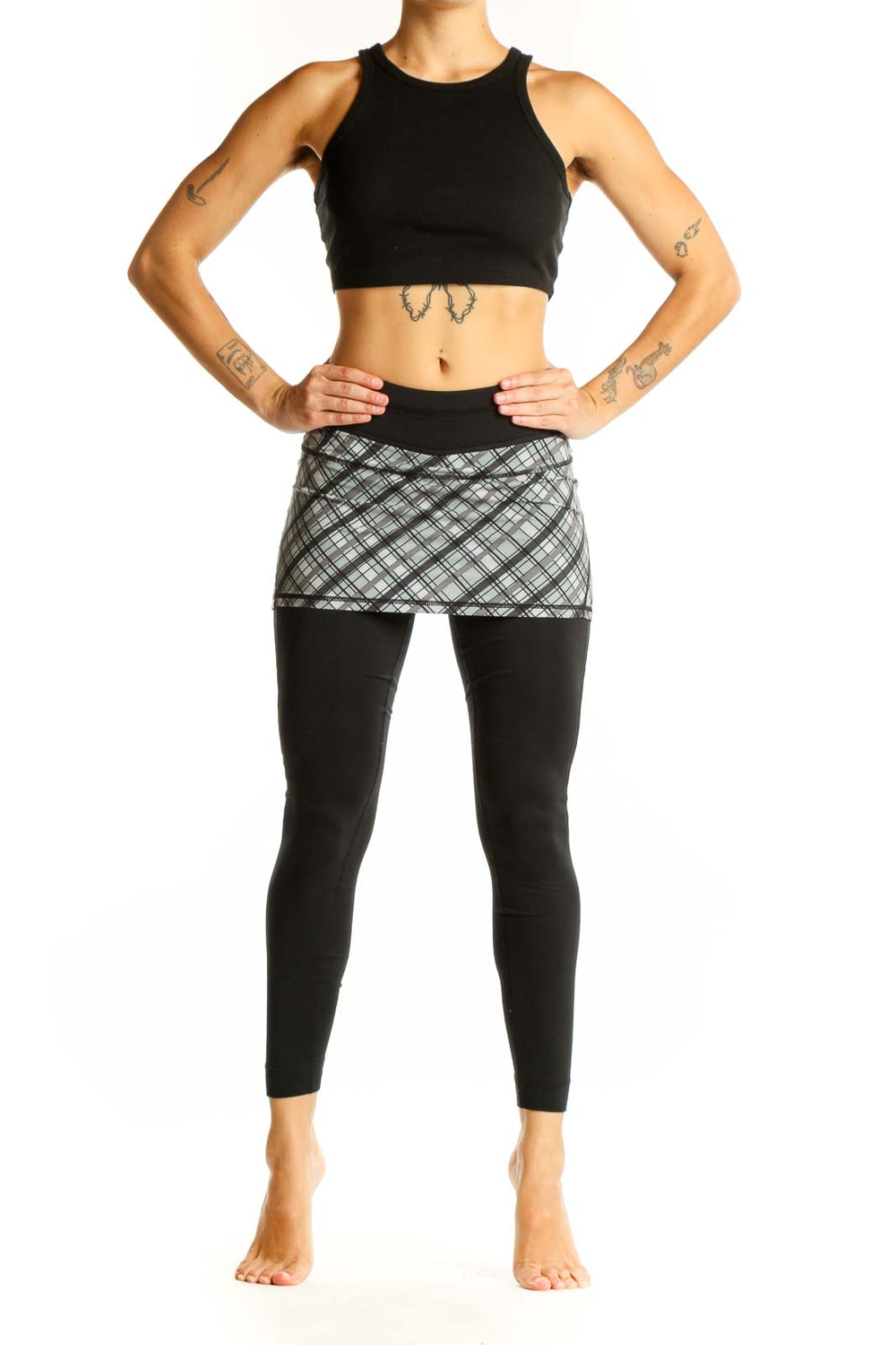 Front view of Athleta black leggings with gray plaid skirt overlay
