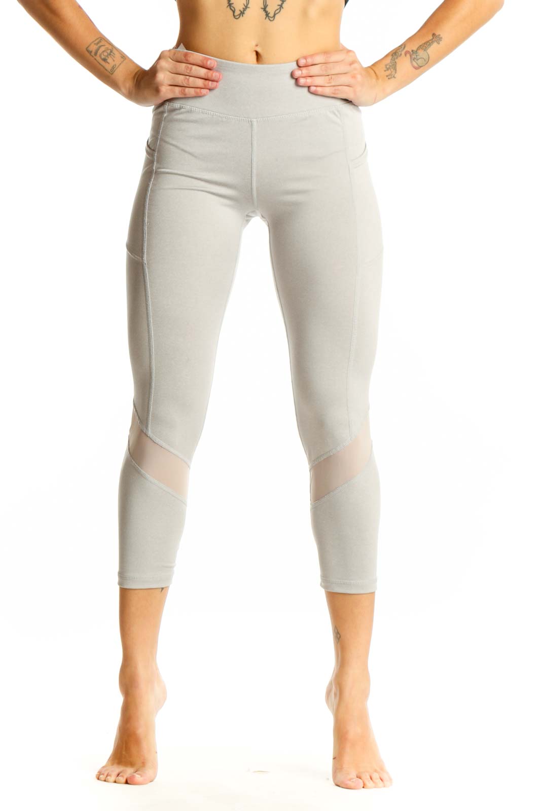 Front view of light gray Reebok capri leggings with mesh panels
