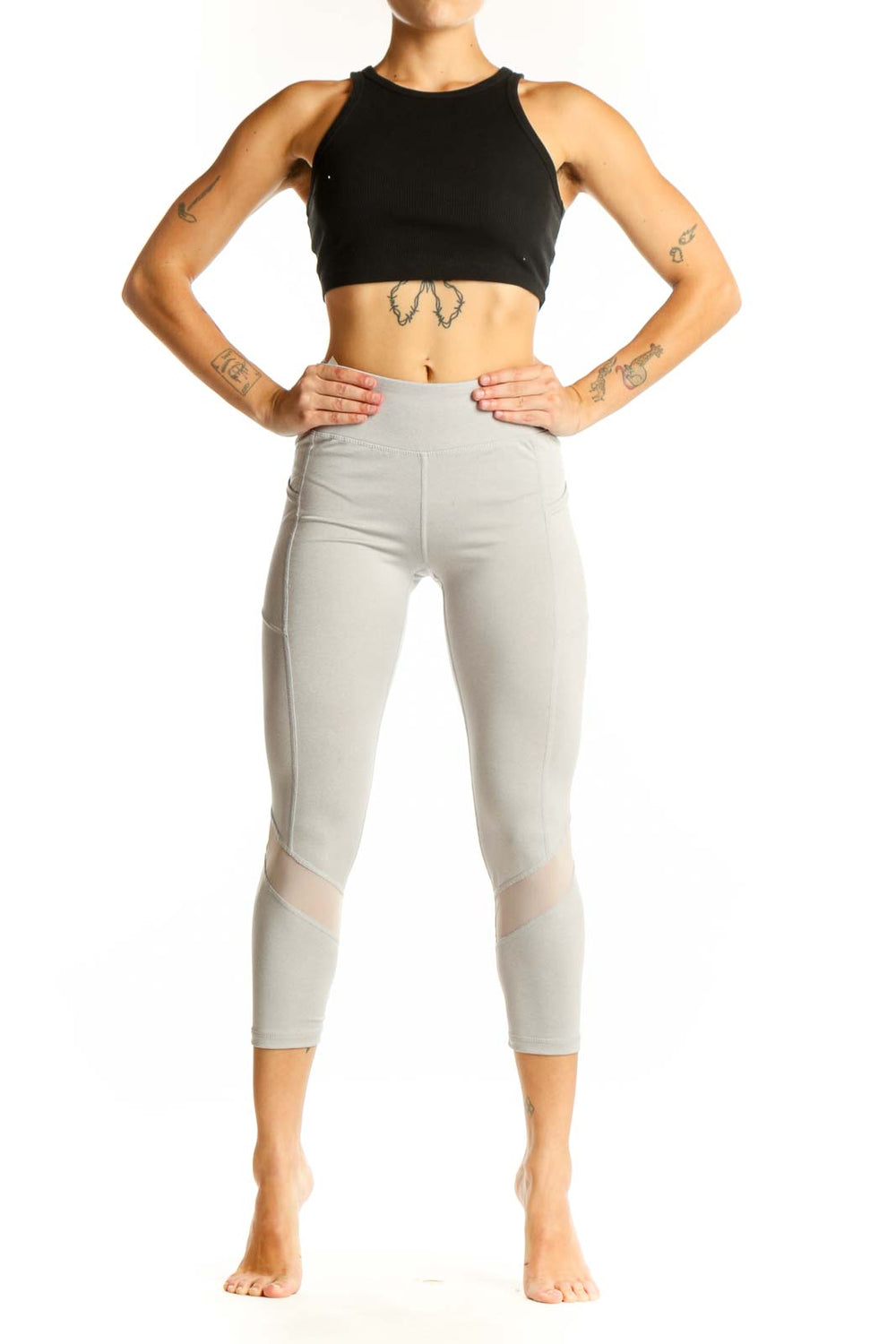 Front view of light gray Reebok capri leggings with mesh panels