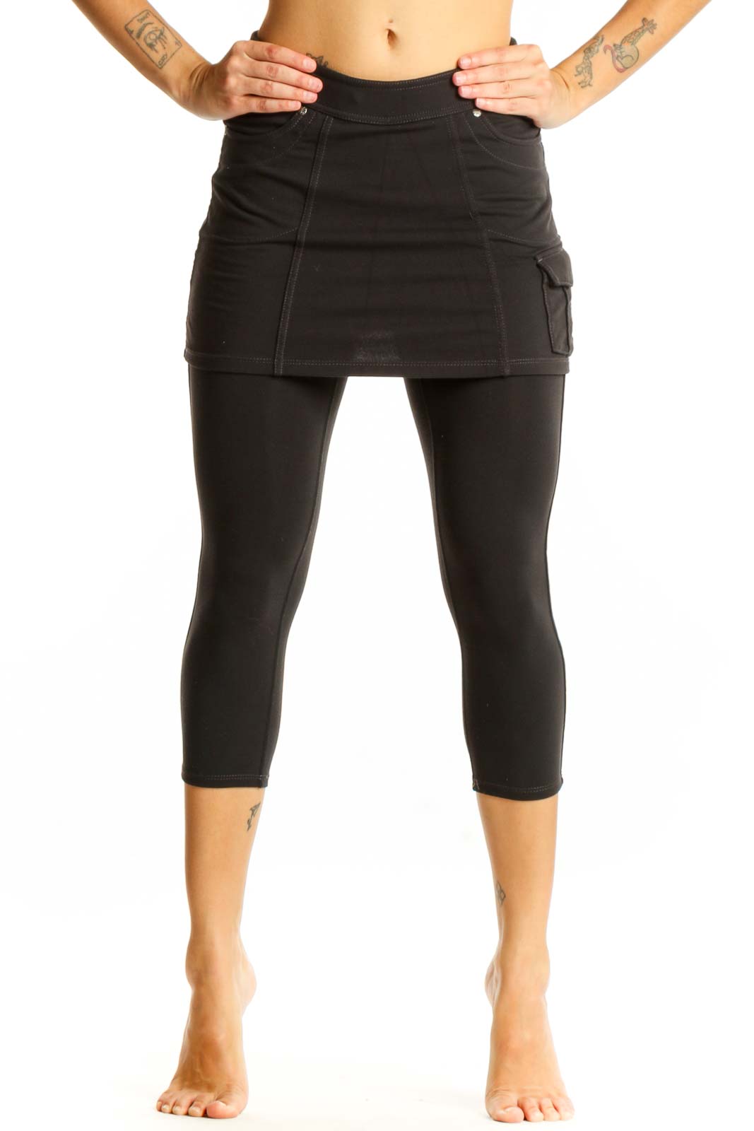 Front view of Athleta black cotton skirted capri leggings on model