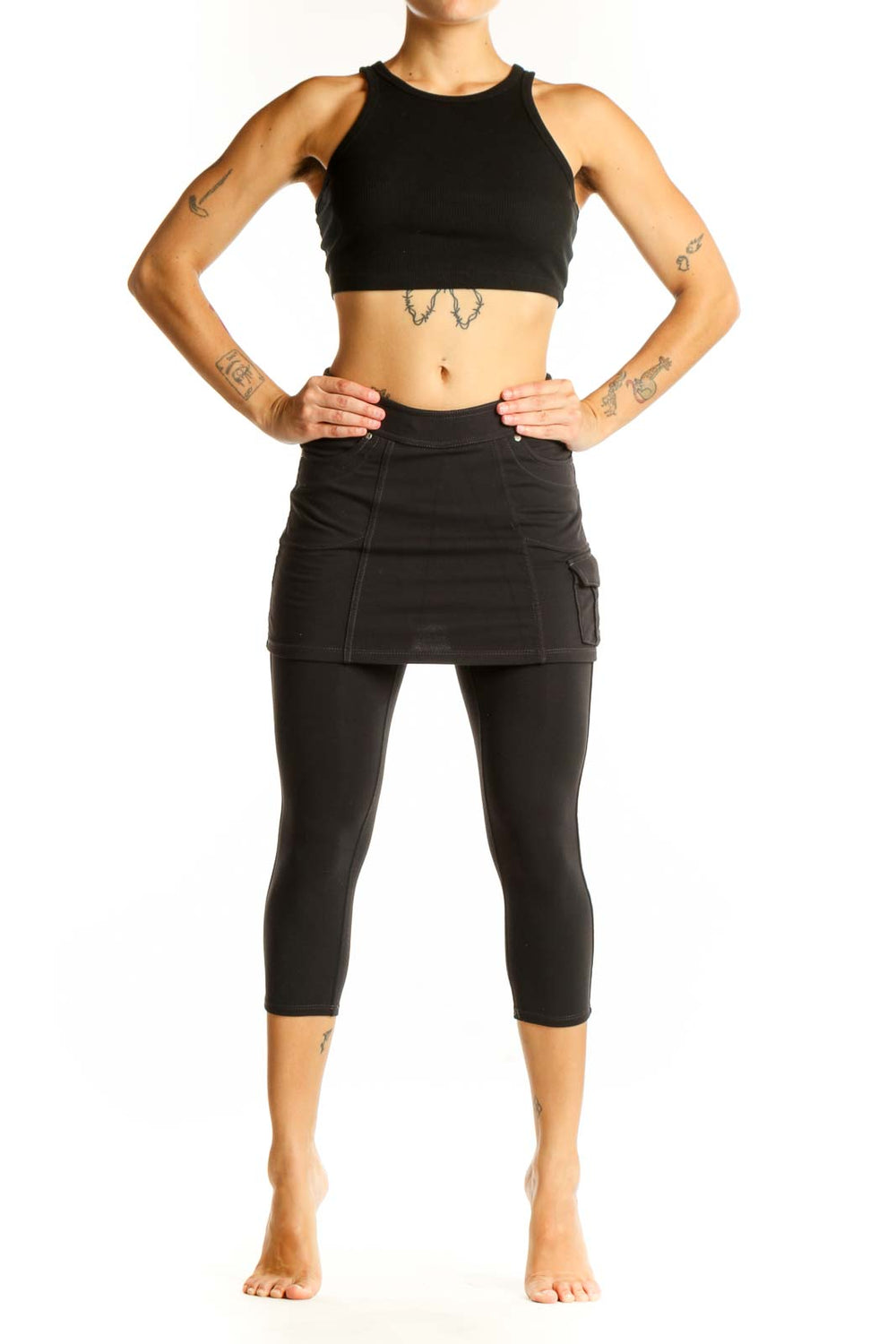 Front view of Athleta black cotton skirted capri leggings on model