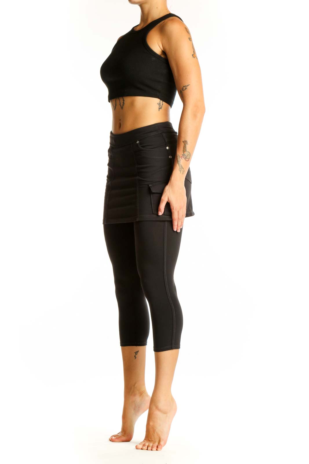 Front view of Athleta black cotton skirted capri leggings on model