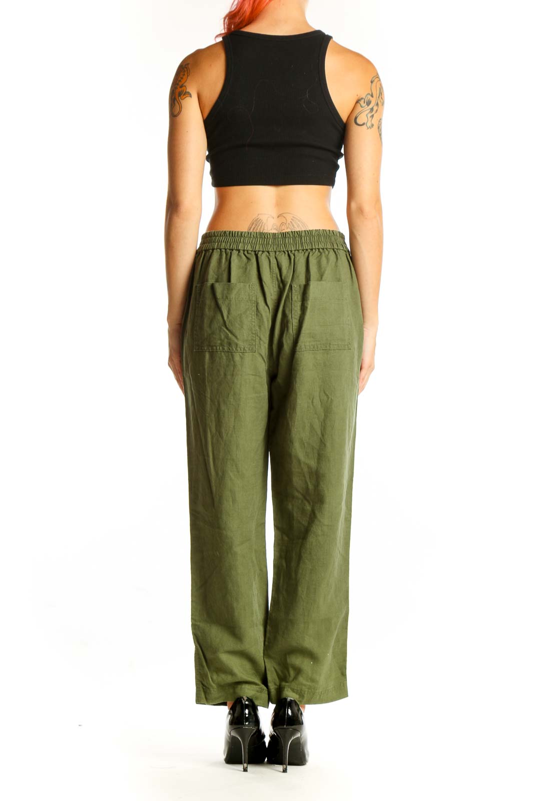 Side view of woman wearing olive green J.Crew drawstring pants with black top