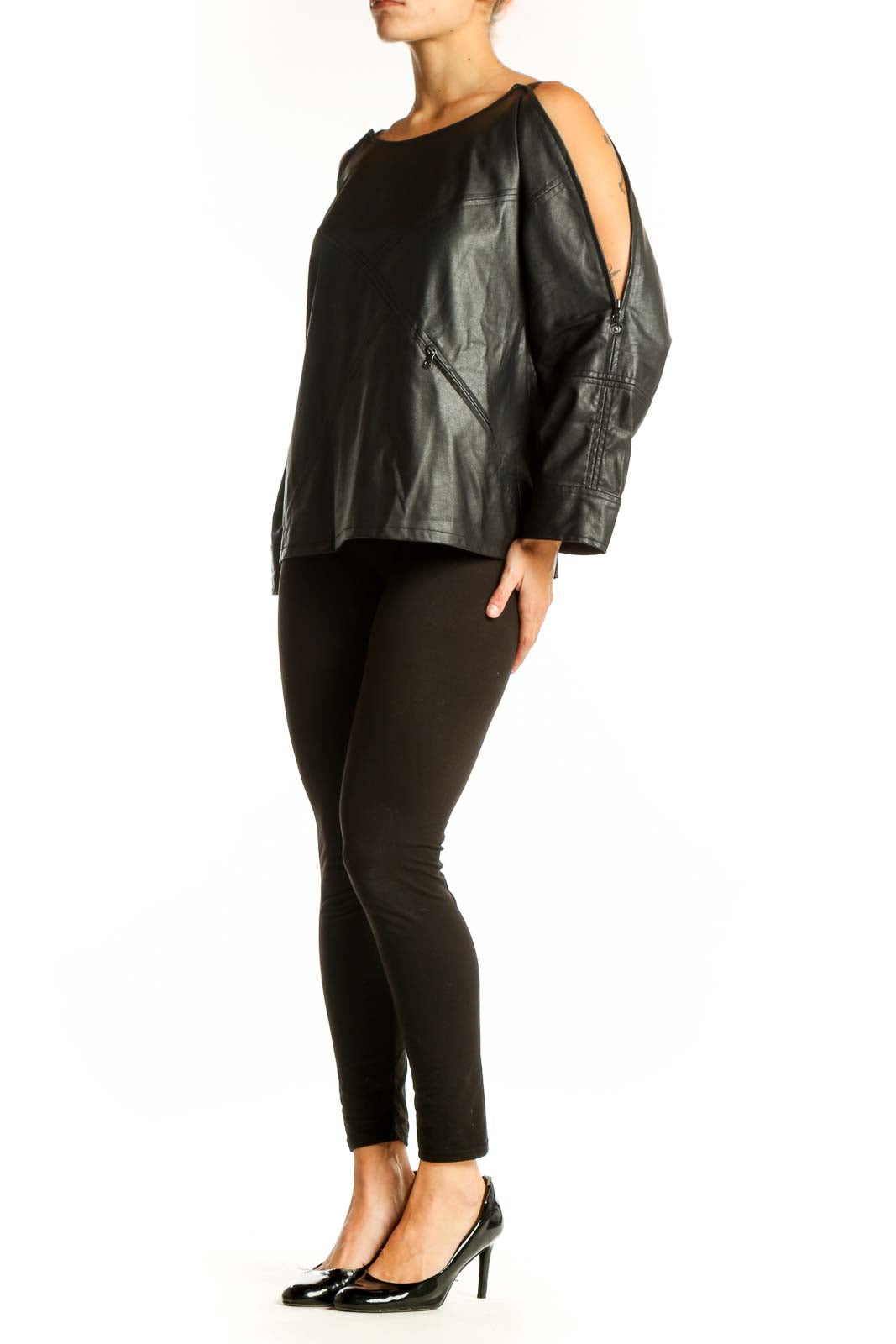 Front view of black leather cold shoulder top with zipper details