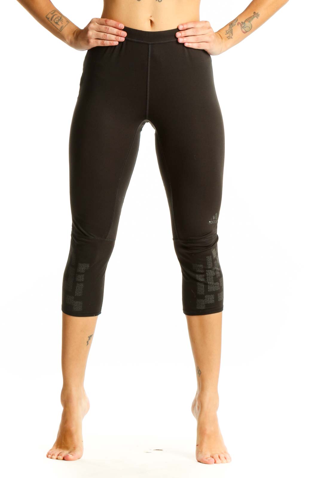Front view of black Adidas capri leggings with patterned lower leg detail