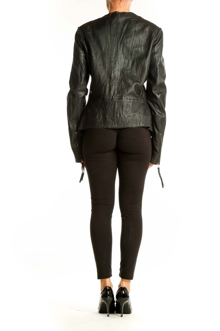 Side view of Topshop black leather biker jacket on model