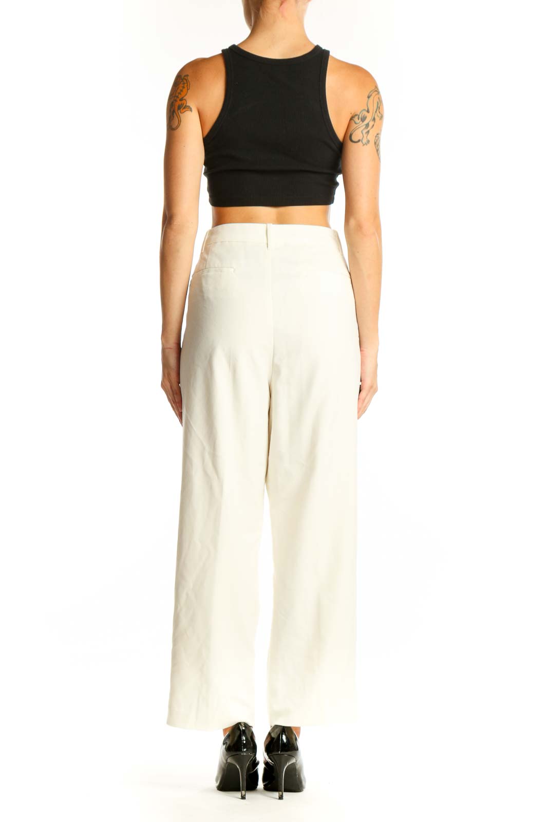 Side view of white wide-leg dress pants paired with black crop top