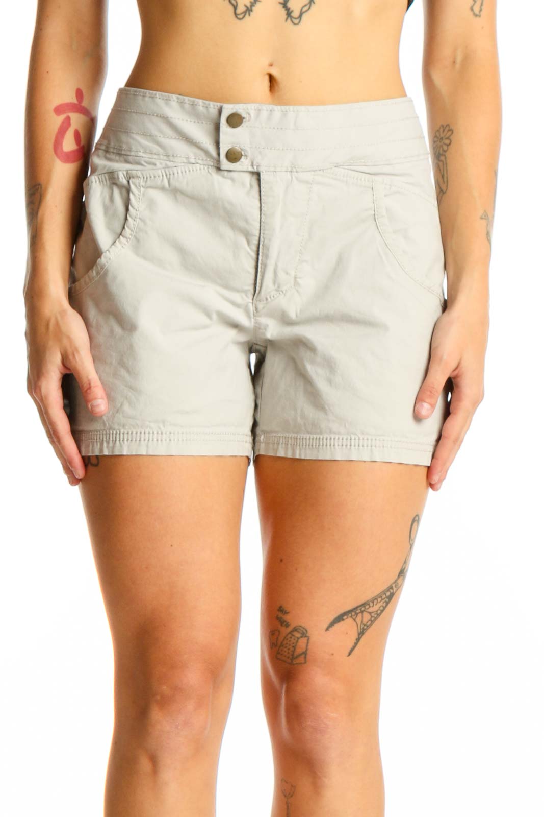 Front view of Nau beige cotton-blend shorts with double-button closure