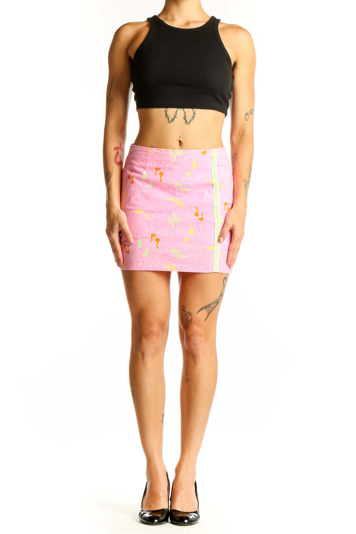Front view of pink Lilly Pulitzer mini skirt with flamingo print and green side stripe