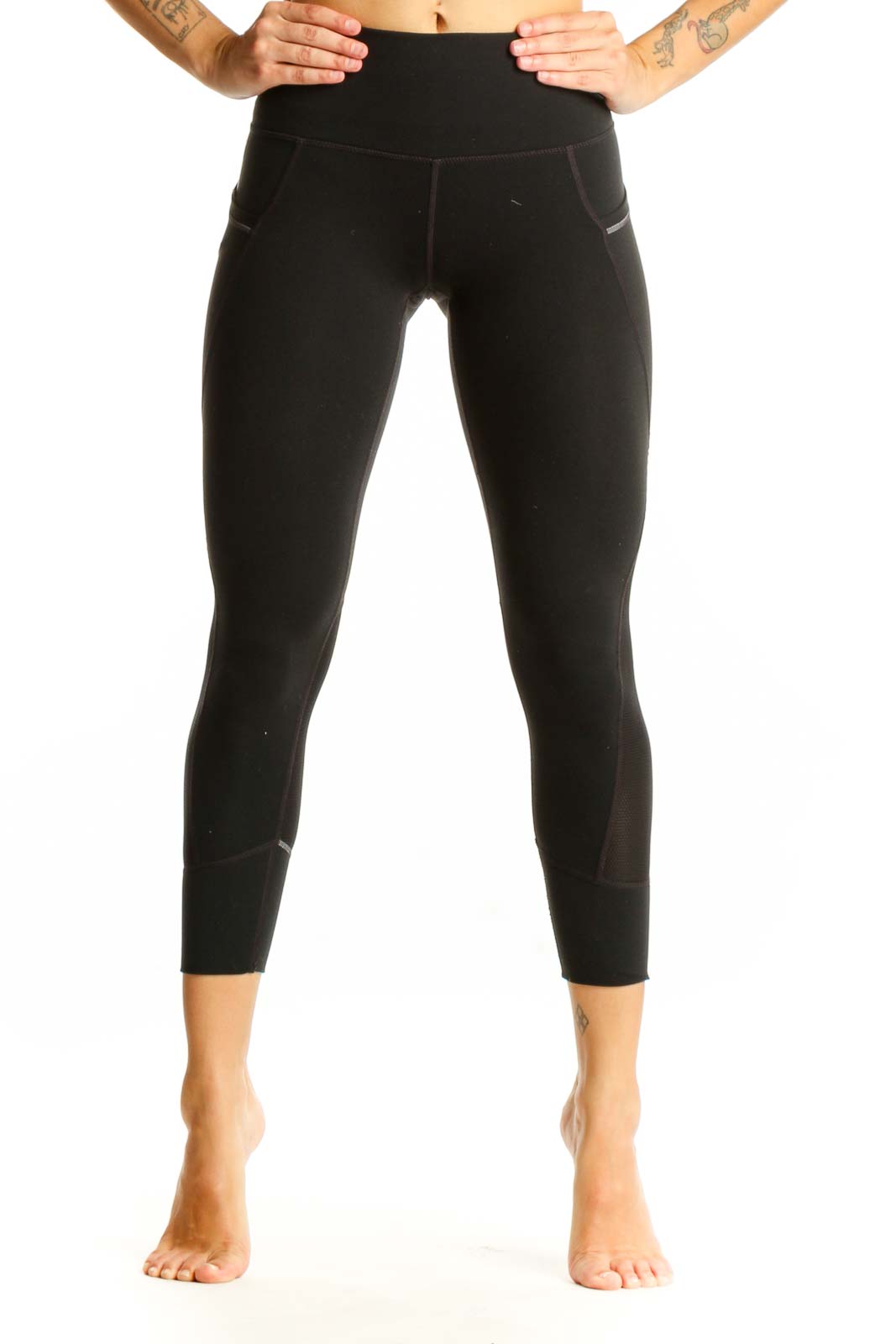 Front view of black Nike high-waisted cropped leggings with side pockets