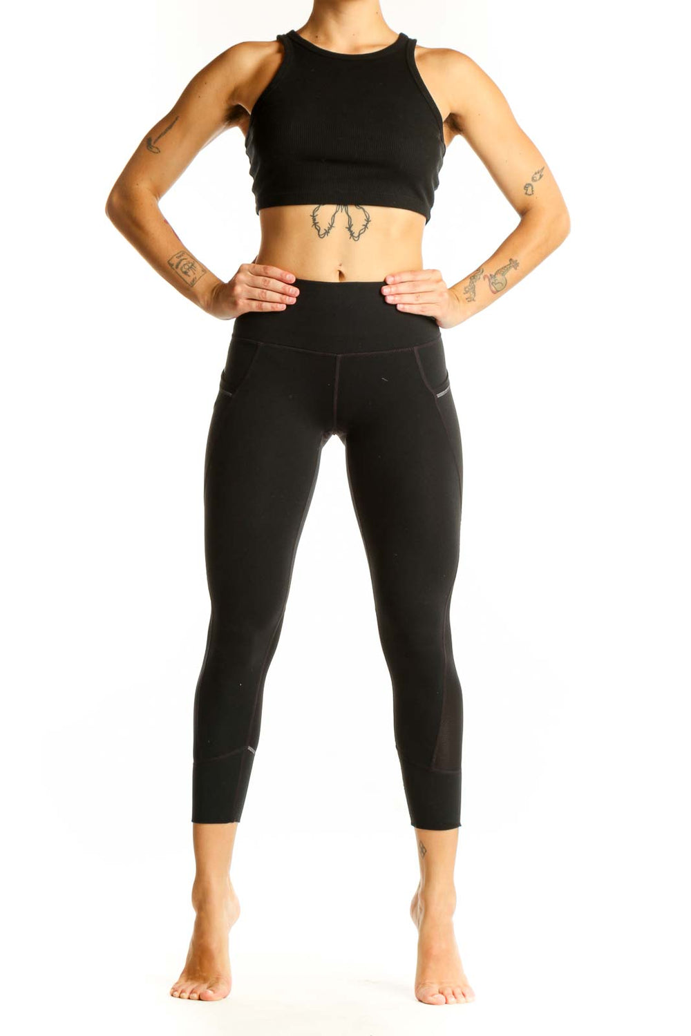 Front view of black Nike high-waisted cropped leggings with side pockets