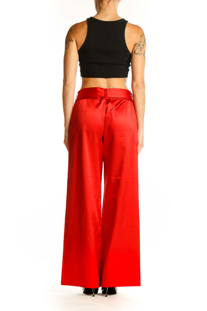Side view of woman wearing red satin wide-leg pants by Armani Exchange