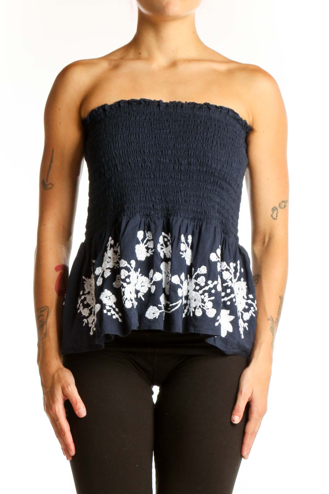 Front view of Point Sur navy strapless top with smocked bodice and floral peplum