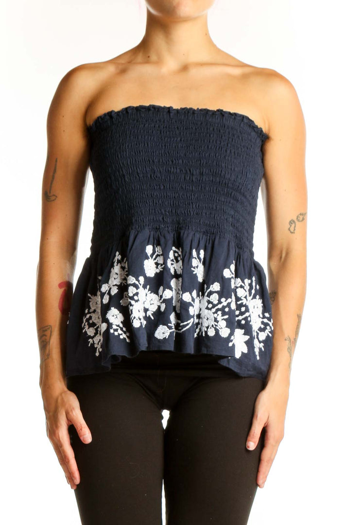 Front view of Point Sur navy strapless top with smocked bodice and floral peplum