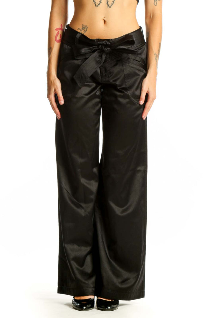 Front view of Armani Exchange black satin wide-leg dress pants with bow detail