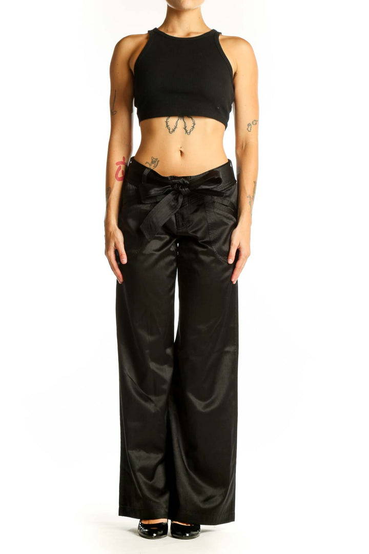 Front view of Armani Exchange black satin wide-leg dress pants with bow detail