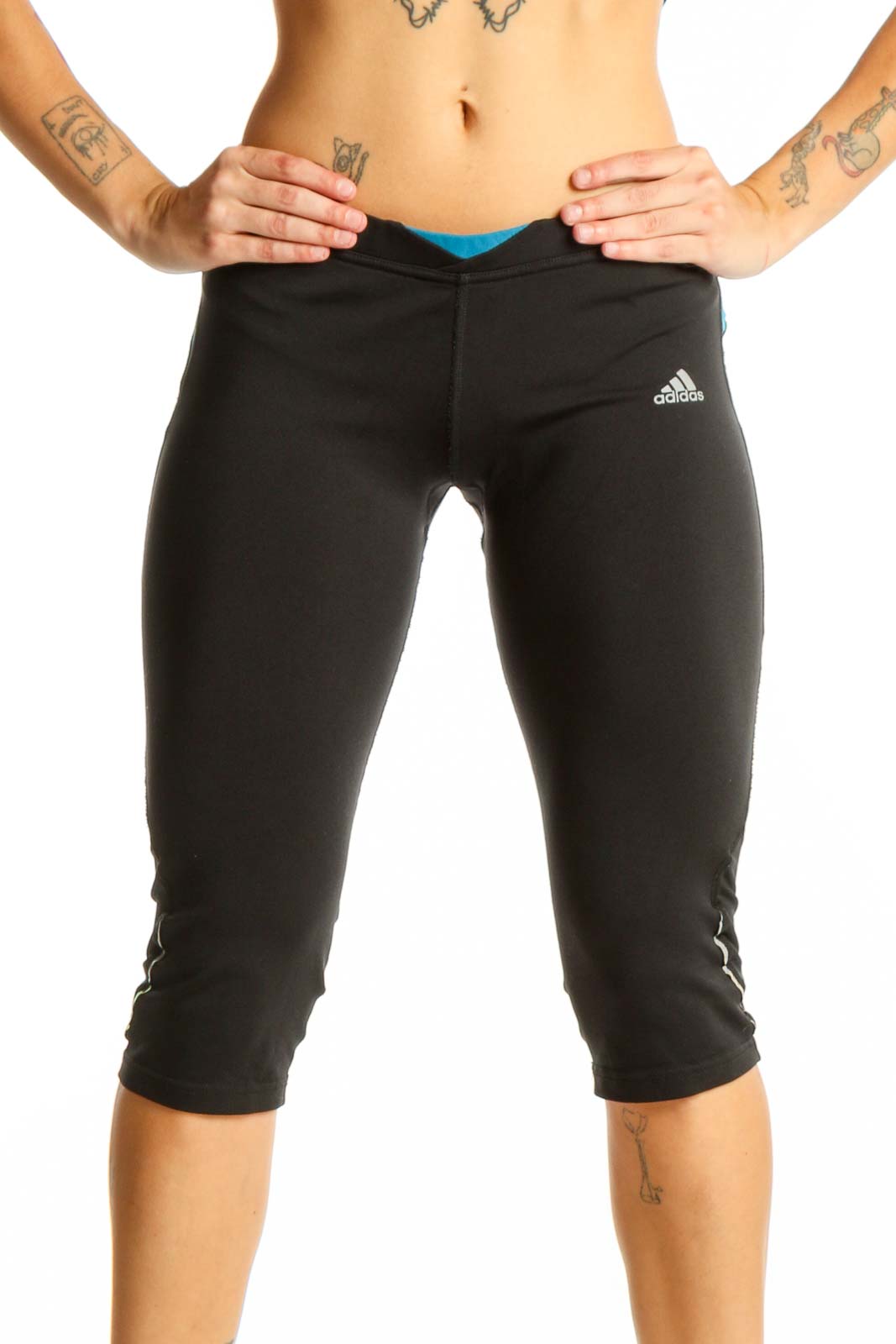 Front view of black Adidas capri leggings with blue accents