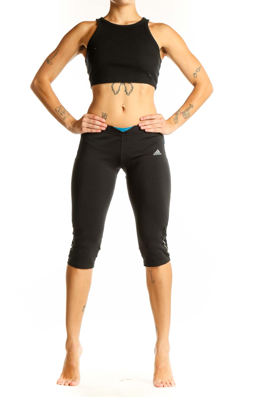 Front view of black Adidas capri leggings with blue accents