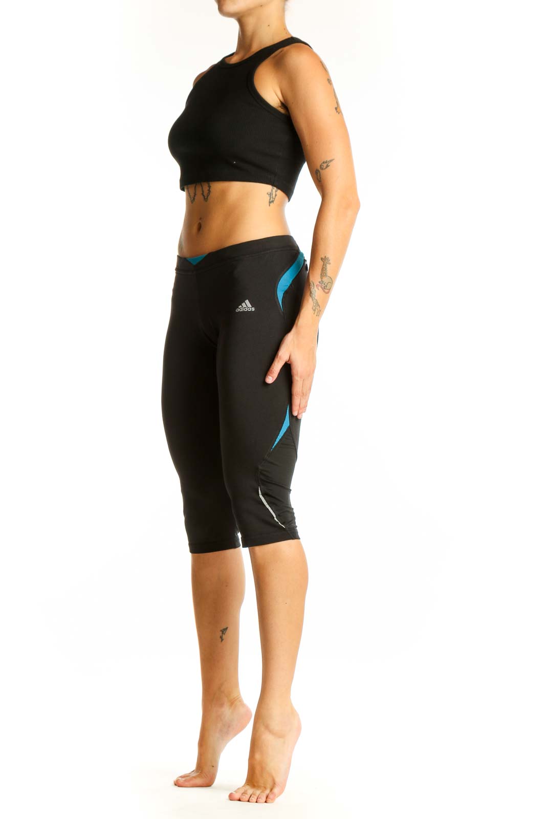 Front view of black Adidas capri leggings with blue accents
