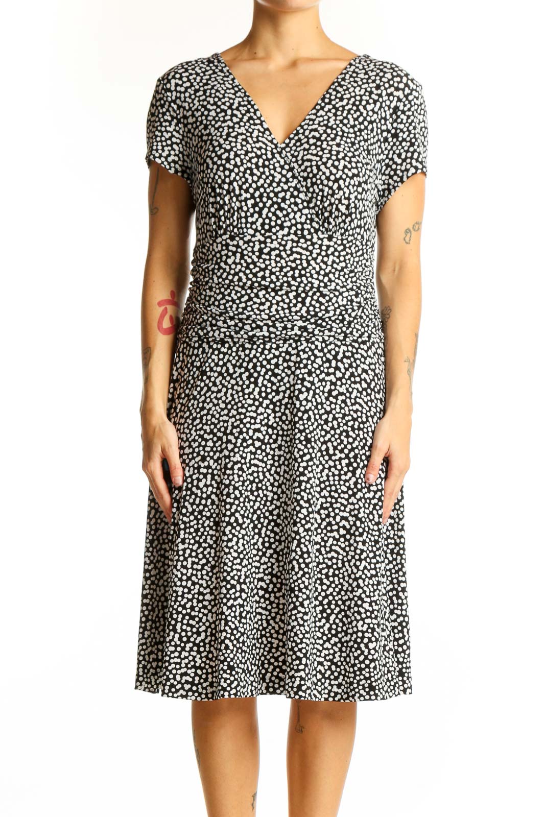 Front view of Connected Apparel black polka dot wrap dress with V-neckline
