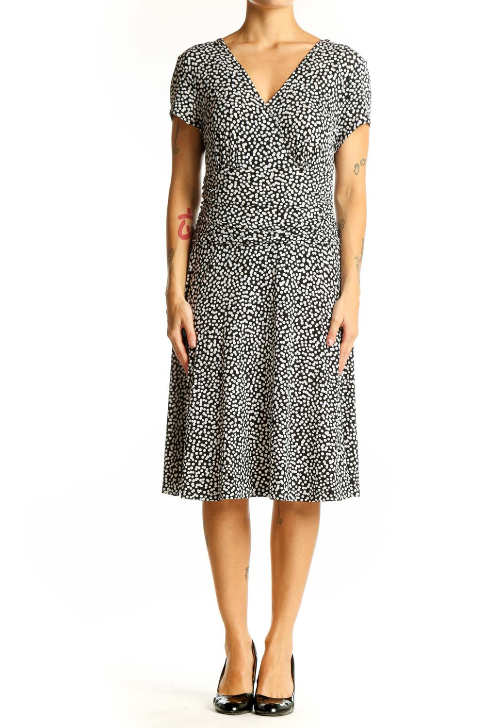 Front view of Connected Apparel black polka dot wrap dress with V-neckline