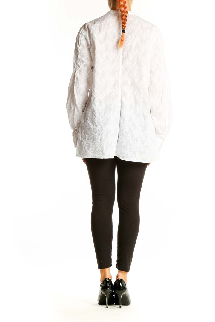 Side view of white cotton button-down shirt from Lands' End on model