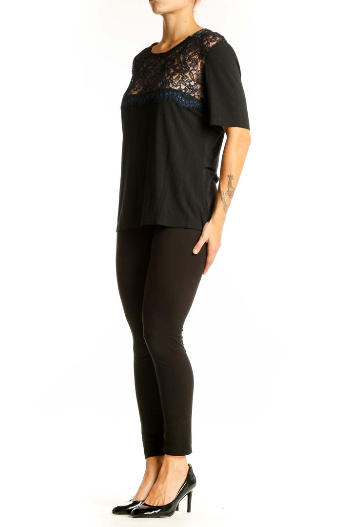 Front view of black St. John Couture top with sparkling lace yoke