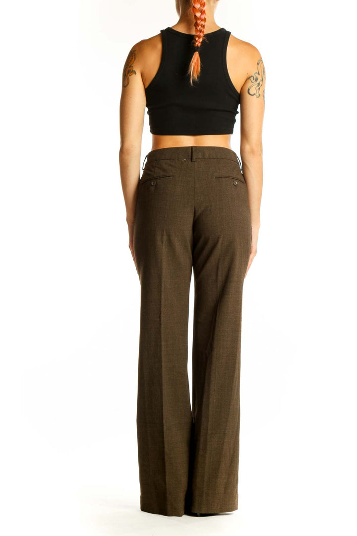 Side view of woman wearing brown wide-leg dress pants from Express Design Studio
