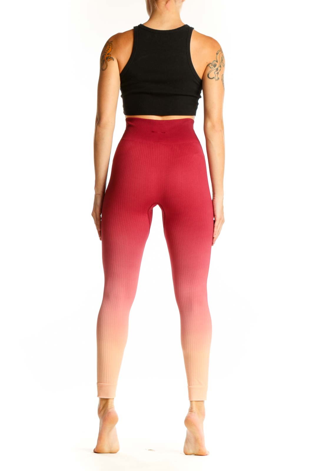 Side view of woman wearing red ombre high-waisted ribbed leggings from The Upside with black crop top