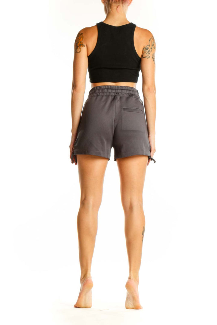 Side view of gray Blanc Noir athletic shorts showing lace-up detail